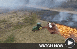 Tractor working in a burning field